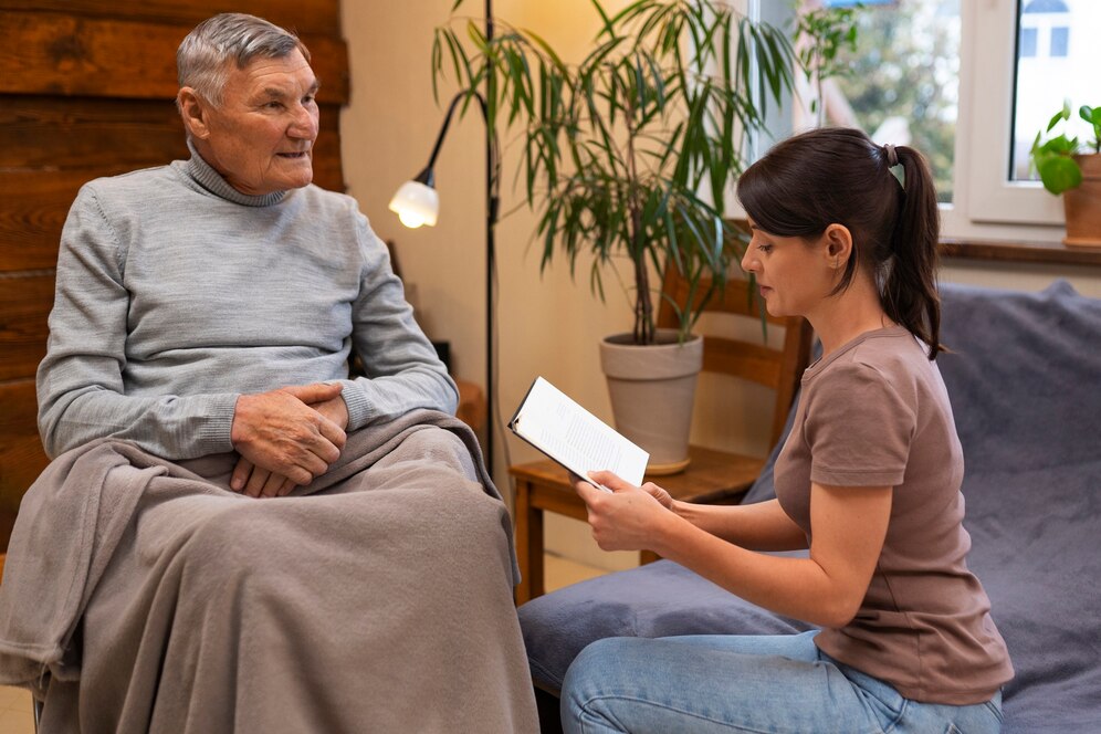 elderly-person-being-taken-care-by-female-caretaker_23-2150216390